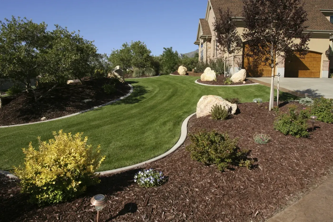 Residential front yard with flower bed walkway in Greater Lansing, MI
